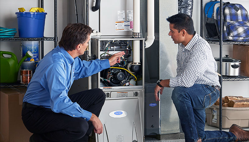 HVAC technician evaluating a furnace for repair or replacement in Syracuse