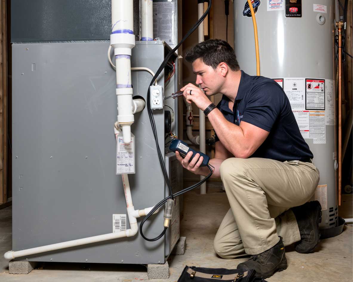 HVAC technician performing a furnace tune-up in Syracuse