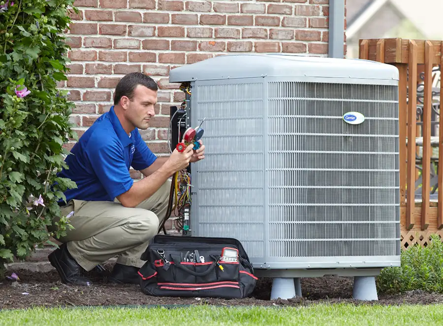 HVAC technician inspecting an outdoor air conditioning unit in Syracuse